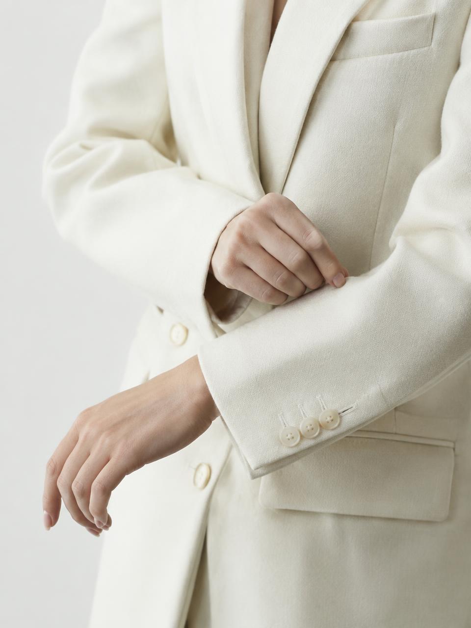 Detail of an ivory wool blazer cuff